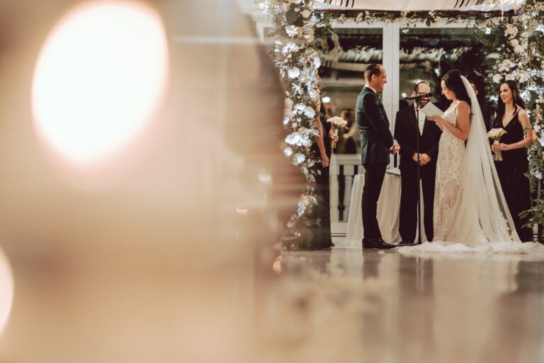 Bride and groom share their vows during their wedding ceremony in Crystal Plaza's Atrium.