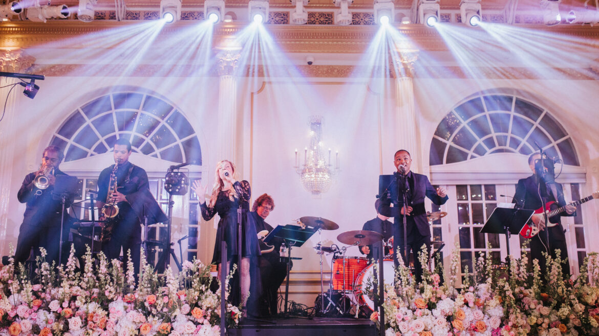 Female and male singer sing with live band in Crystal Plaza's grand ballroom.