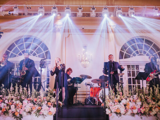 Female and male singer sing with live band in Crystal Plaza's grand ballroom.