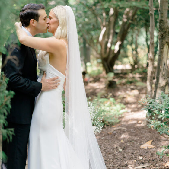 Bride and groom kiss in the garden at Crystal Plaza.