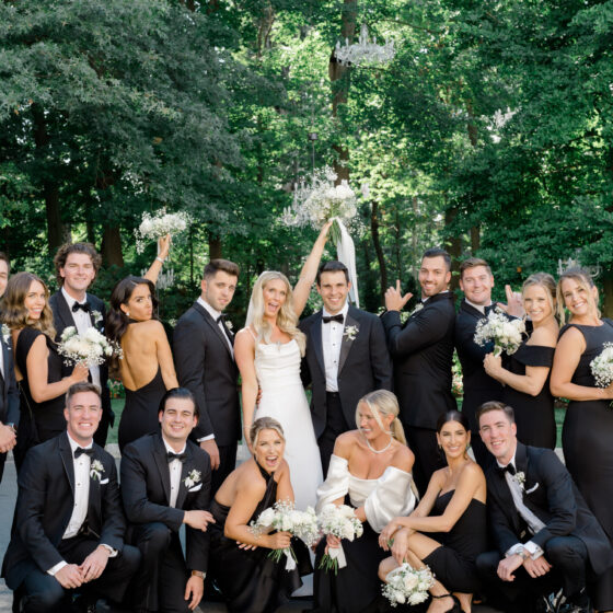 Fun bride, groom, and bridal party photo in Crystal Plaza's garden.