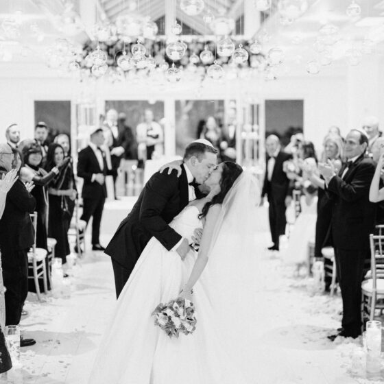 Black and white photo of just married bride and groom in Crystal Plaza's Atrium venue space.