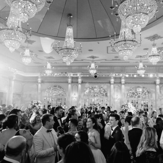 Black and white image of guests dancing in Crystal Plaza's grand ballroom.