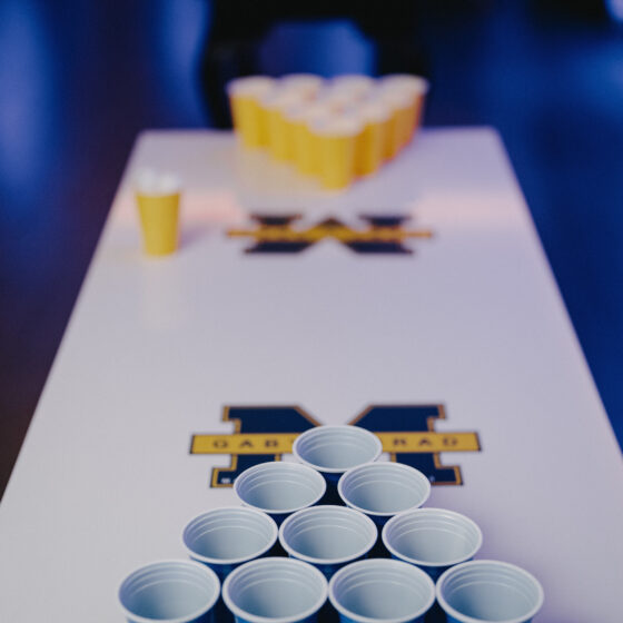 Fun beer pong table themed for bride and groom's alma mater college.