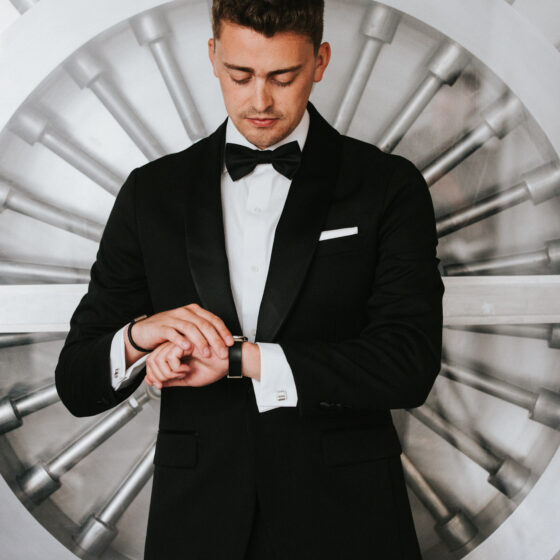Groom checks his watch in front of the band vault door at Crystal Plaza.