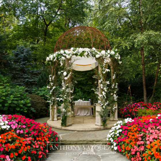 Beautiful garden wedding ceremony decor with colorful flowers.