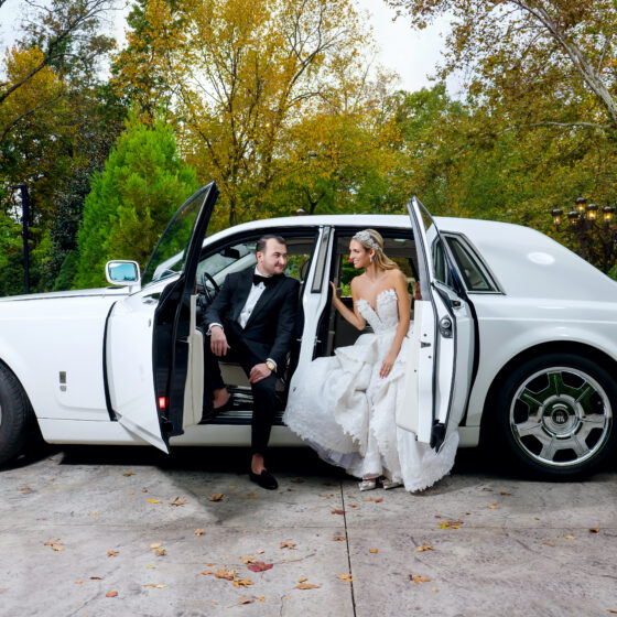 Bride and groom wedding portrait with luxurious white car.
