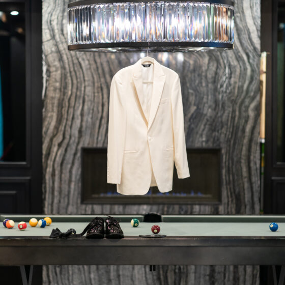 Grooms jacket and dress shoes sit on the pool table in the Vault, a stylish space to get ready in before the wedding.