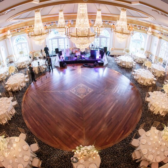 Overview shot of Crystal Plaza's grand ballroom set up for a wedding reception.
