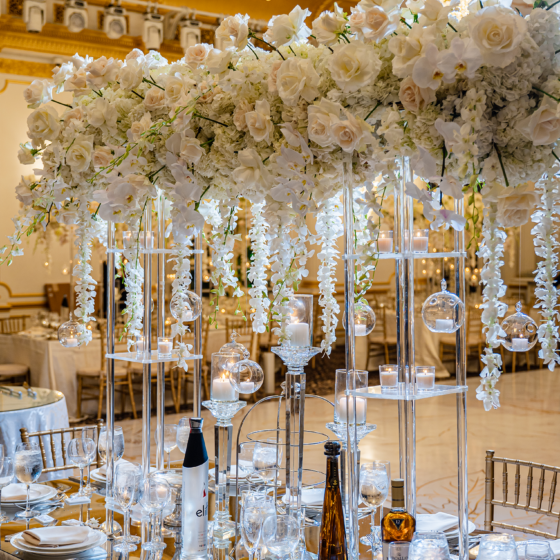 Tall white rose wedding reception centerpiece.