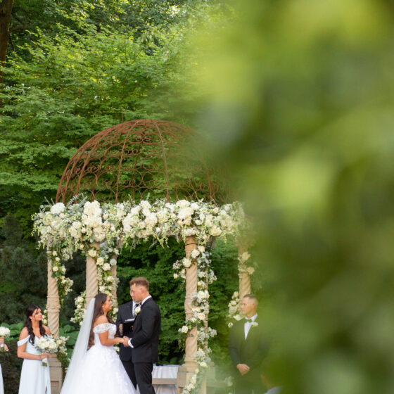 Bride and groom exchange vows during their garden wedding ceremony at Crystal Plaza.