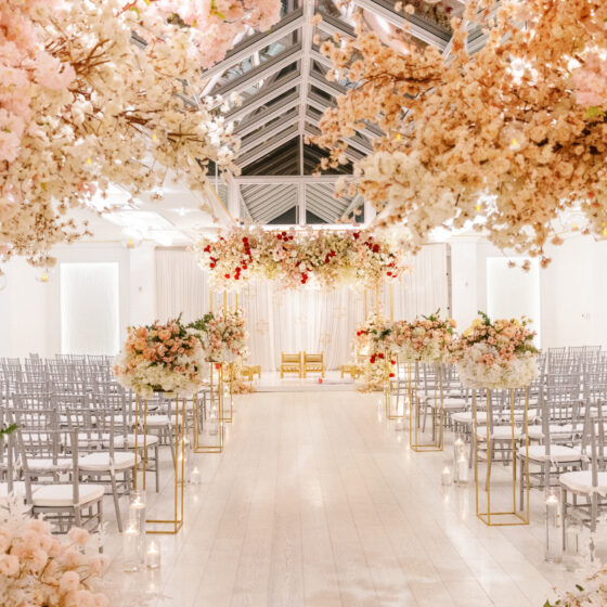 Pink and white flower wedding ceremony decor in Crystal Plaza's Atrium venue space.