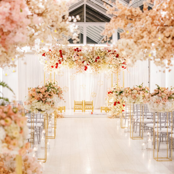 Pink and white flower wedding ceremony decor in Crystal Plaza's Atrium venue space.