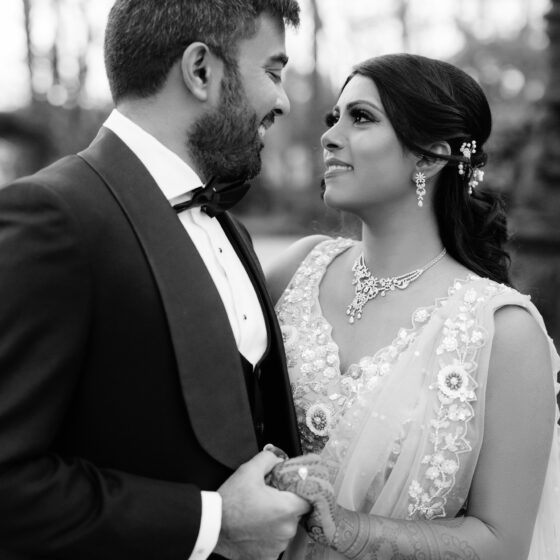 Black and white photo of bride and groom lovingly looking at each other.