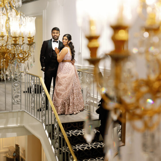 Bride and groom pose for wedding portraits on Crystal Plaza's staircase.