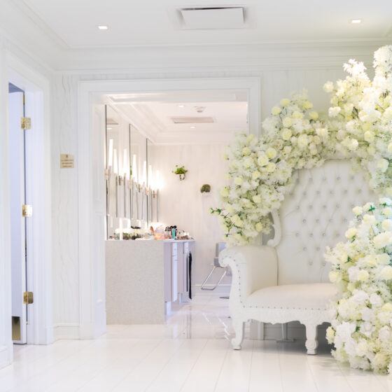 Large white chair decorated with white flowers in Crystal Plaza's Penthouse Suite.