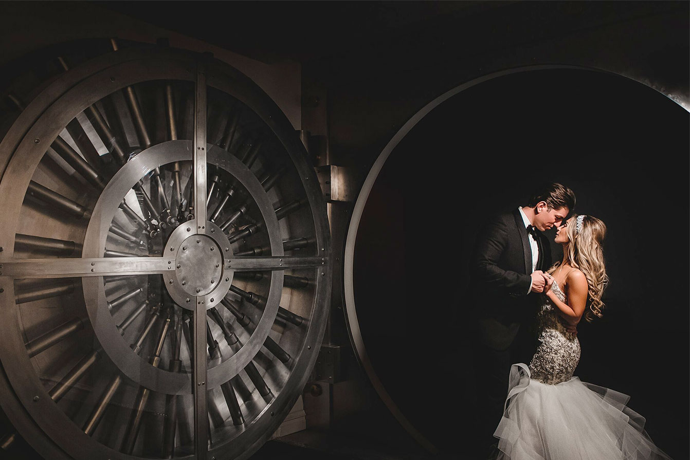 Bride and groom pose in front the Vault at Crystal Plaza.